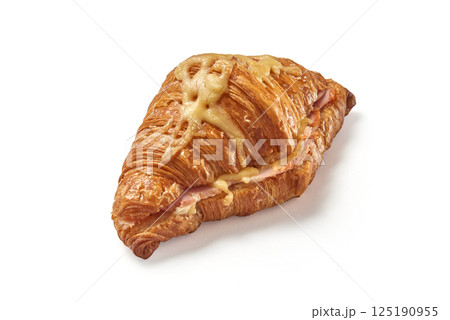 Homemade delicious cut croissant with ham inside and cheese on top isolated Homemade delicious cut croissant with ham inside and cheese on top isolated 125190955