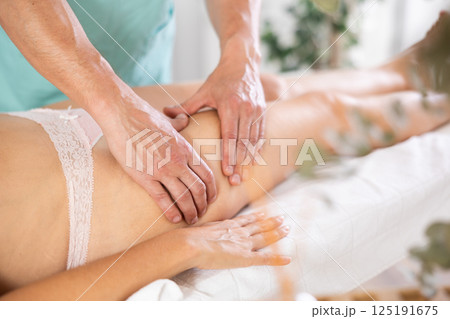 the client lies while the worker gives a massage the client lies while the worker gives a massage 125191675