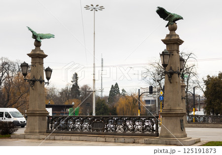 Busy traffic on ancient bridge over Perlovska River passes through Eagles Bridge. 125191873