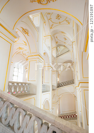 Internal staircase in palace, walls are decorated with gold-colored monograms in Bratislava castle Internal staircase in palace, walls are decorated with gold-colored monograms in Bratislava castle 125191897