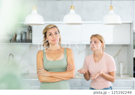 Teenage daughter asking mother to forgive after argument 125192249
