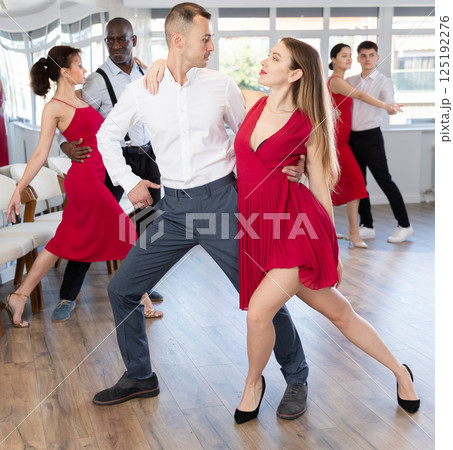 Adult man and young woman dancing tango Adult man and young woman dancing tango 125192276