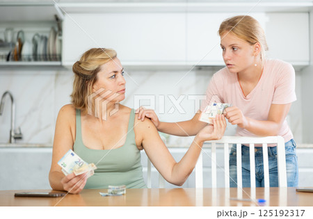 Woman received salary giving pocket money to teenage daughter Woman received salary giving pocket money to teenage daughter 125192317