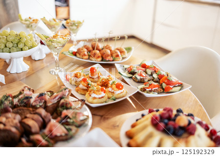 Close-up of delicious snacks on a wooden table in the dining room at home 125192329