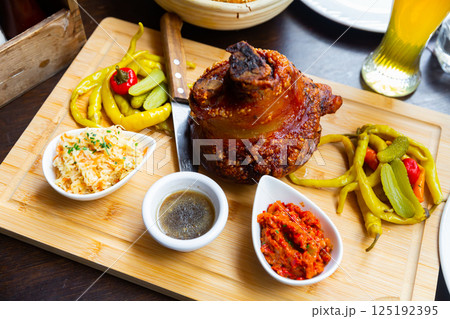 Schweinsstelze on wooden serving board 125192395