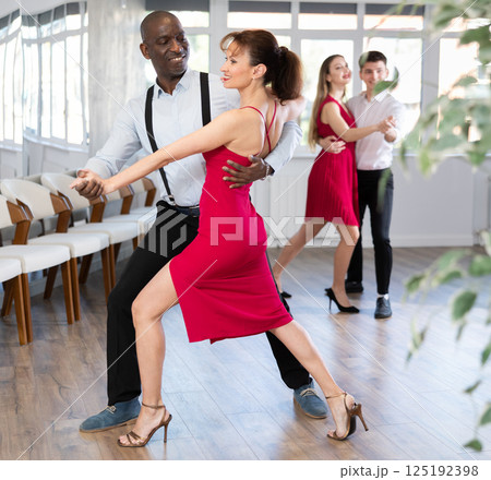 Adult man and adult woman dance tango 125192398