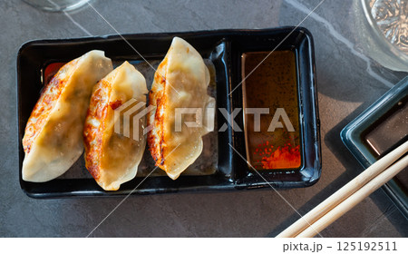Japanese gyoza dumplings served on platter 125192511