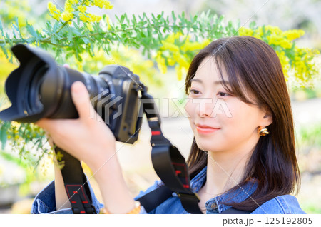 花を撮影する若い女性カメラマン 花を撮影する若い女性カメラマン 125192805