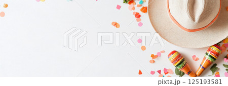 Cinco de Mayo and Dia de los Muertos background with sombrero, maracas and colorful confetti 125193581