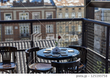 Terrace with table and chairs against the backdrop of a European city 125193758