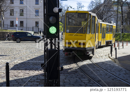 A tram traffic light which has a green light illuminated on it right now 125193771