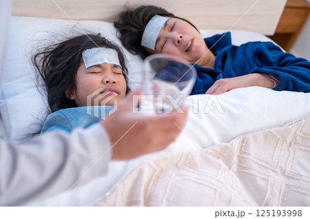 体調不良の家族を看病する男性 体調不良の家族を看病する男性 125193998