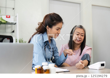 Patient Education and Support. A nurse explains health information to an elderly patient. 125194279