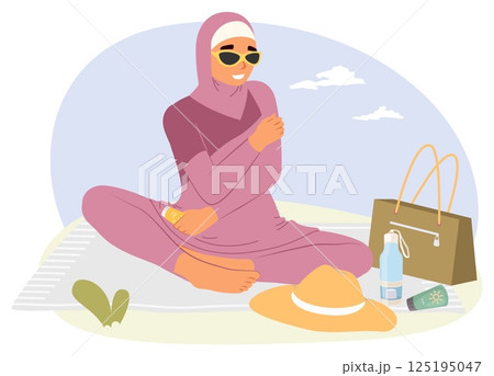 A woman dressed in a stylish outfit sits comfortably on a blanket outdoors, wearing sunglasses 125195047