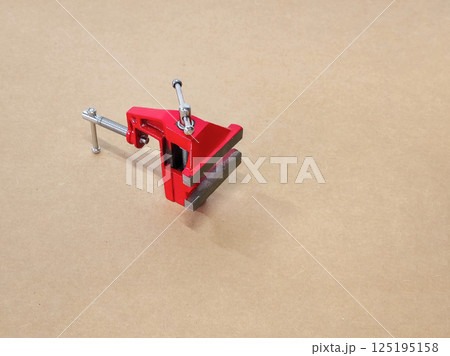 Small red vise close up. 125195158