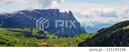 Majestic mountain landscape view of verdant valleys and snow capped peaks in early spring near Valley of Funes at Dolomites, Italy 125195196