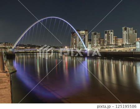Nightscape scenery of The Iconic gateshead millennium bridge spanning the River Tyne and Baltic flour mills with Dark sky. Nightscape scenery of The Iconic gateshead millennium bridge spanning the River Tyne and Baltic flour mills with Dark sky. 125195586