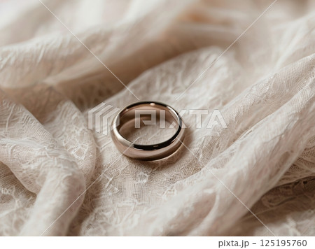 Elegant Wedding Ring on Delicate Lace with Soft White Rose 125195760