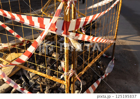 structure is metal with a red and white ribbon, dangerous territory. structure is metal with a red and white ribbon, dangerous territory. 125195837
