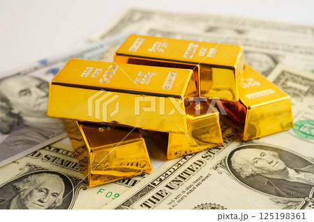 Gold bars on US dollar banknote money, finance trading investment business currency concept. Gold bars on US dollar banknote money, finance trading investment business currency concept. 125198361
