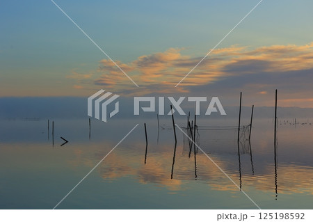 朝焼けの霧立つ沼の朝 125198592