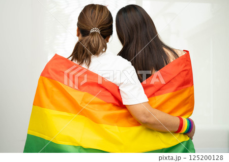 Asian couple woman with LGBT rainbow flag. 125200128