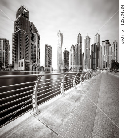 Skyscrapers and bridge over water, black and white style, city background, Dubai Marina bay UAE Skyscrapers and bridge over water, black and white style, city background, Dubai Marina bay UAE 125204984