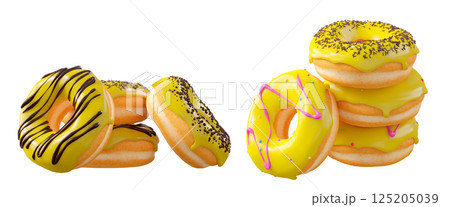 Donuts with yellow lemon glaze, sprinkles, white drizzle, and dots isolated on white transparent background 125205039
