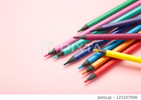 Color pencils on pink background. Space for text 125207006