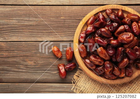 Fresh dates on plate on grey background. Close up Fresh dates on plate on grey background. Close up 125207082