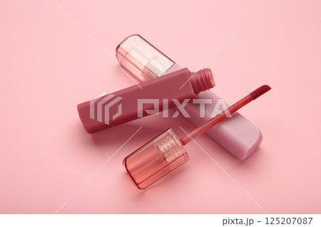 Lip gloss bottle on pink background. Macro photo Lip gloss bottle on pink background. Macro photo 125207087