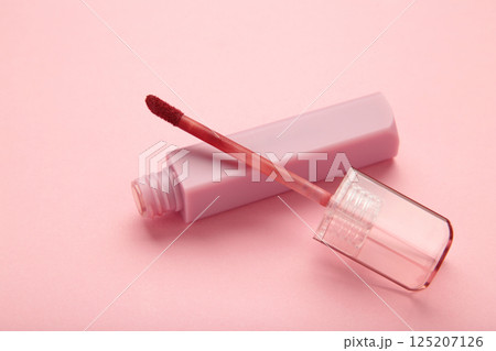 Lip gloss bottle on pink background. Macro photo Lip gloss bottle on pink background. Macro photo 125207126