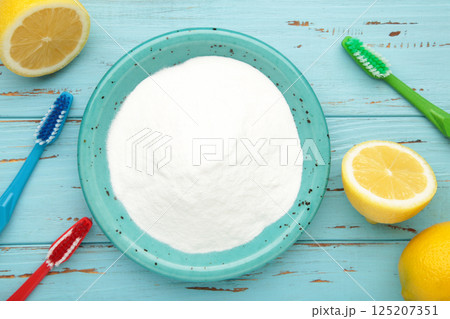Toothbrush and baking soda to clean on blue background. 125207351