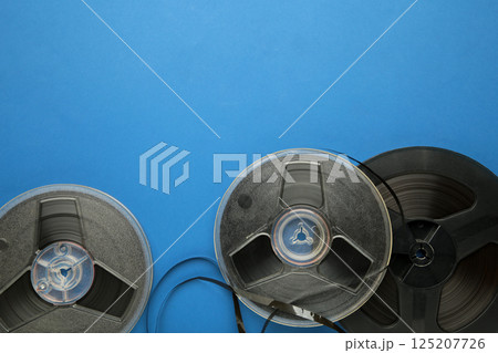 Film reel on blue background. Space for text Film reel on blue background. Space for text 125207726
