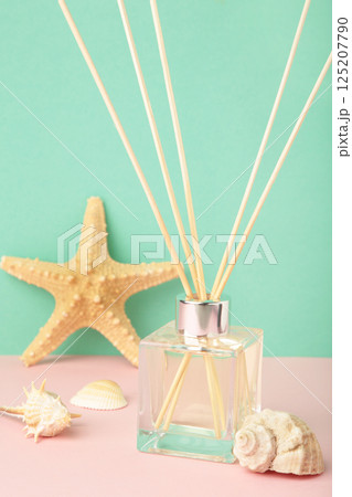 Reed diffuser and sea shells on mint background. Vertical photo Reed diffuser and sea shells on mint background. Vertical photo 125207790