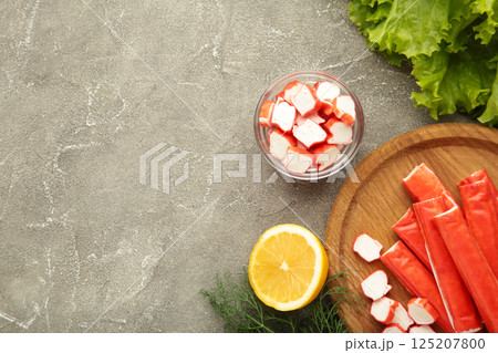 Cut crab sticks in bowl on grey concrete background. Space for text Cut crab sticks in bowl on grey concrete background. Space for text 125207800