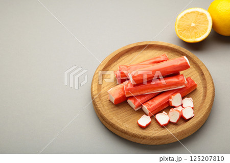 Cut crab sticks in bowl on grey background. Space for text Cut crab sticks in bowl on grey background. Space for text 125207810