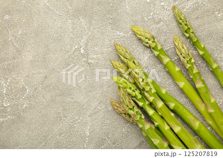 Fresh green asparagus on grey background. Healthy food concept. Vegan healthy food. 125207819