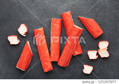 Whole crab sticks on dark blue background 125207857