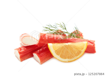 Delicious, fresh crab sticks with slice of lemon isolated on white background. Delicious, fresh crab sticks with slice of lemon isolated on white background. 125207864