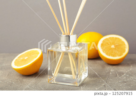 Reed diffuser and lemons on grey concrete background Reed diffuser and lemons on grey concrete background 125207915