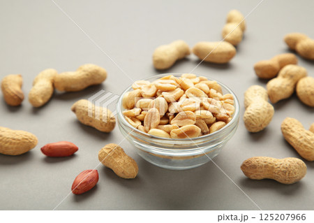 Roasted peanuts on bowl on grey background 125207966
