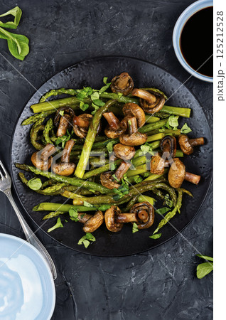 Roasted juicy asparagus with champignons. 125212528