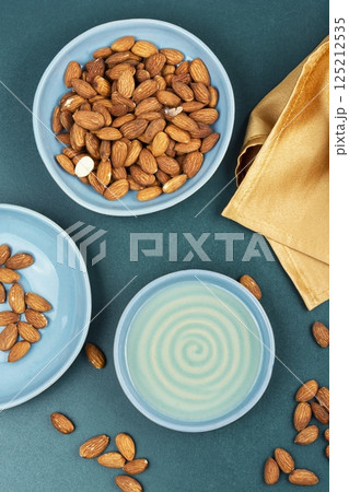 Healthy almond oil and shelled nuts. 125212535