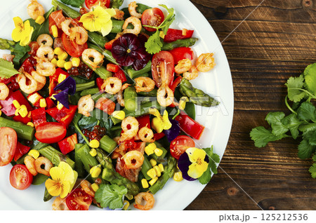 Fresh healthy shrimp salad on wooden surface, modern kitchen. 125212536