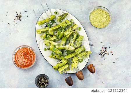 Green celery sticks on skewers, veggie style. 125212544