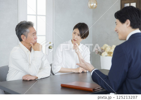 ミーティングをする営業マンとシニアと家族 ミーティングをする営業マンとシニアと家族 125213207