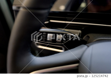 Close up view of car light switch control. Headlight switch, turn signal lever 125214742