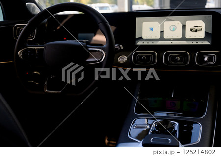 Black steering wheel, automatic transmission,control display in a modern car. Black steering wheel, automatic transmission,control display in a modern car. 125214802