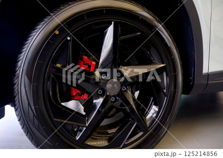 Car wheel with red brake calipers and stylish design. Car wheel with red brake calipers and stylish design. 125214856